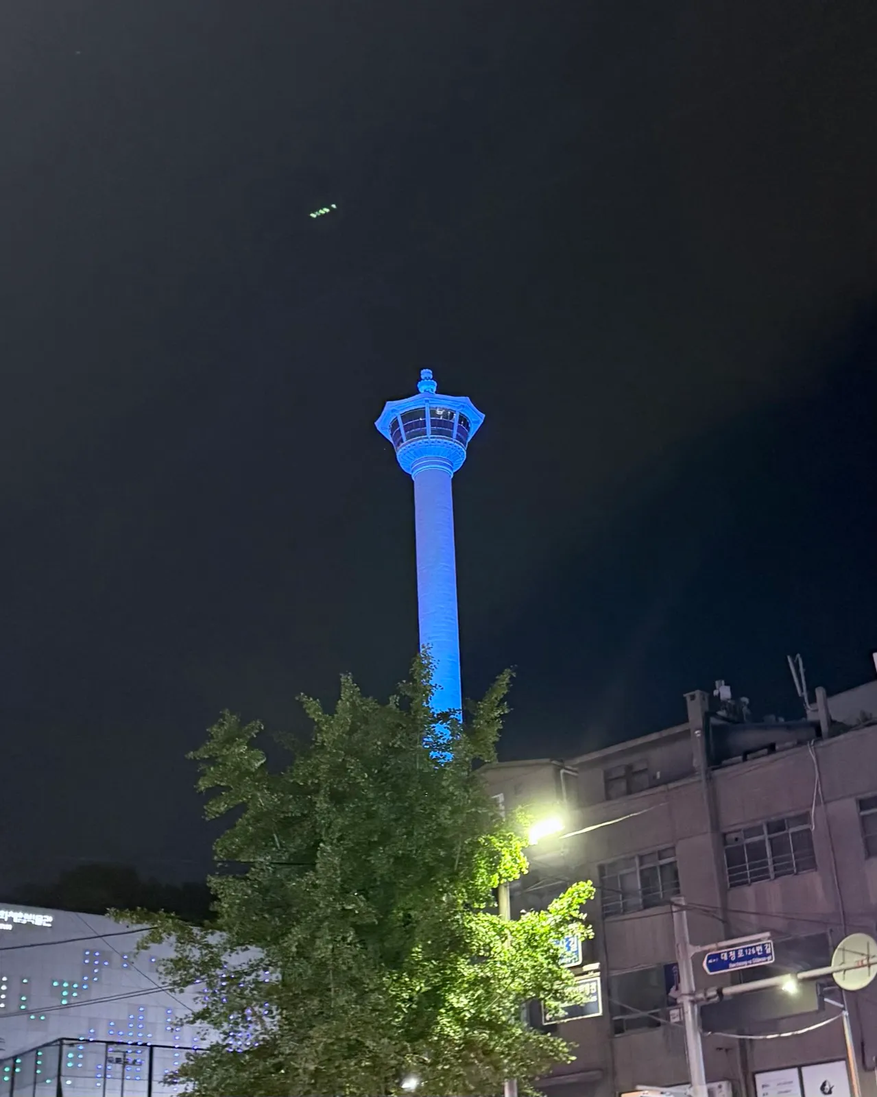 Busan Tower lit up in blue at night